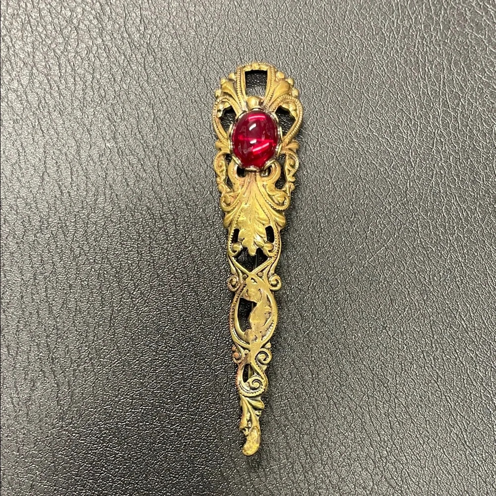 Filigree gold toned, brooch pin with red stone